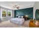 Serene main bedroom featuring a designer accent wall, soft carpet, and lots of natural light at 45 Iris Dr, Youngsville, NC 27596