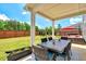 Covered patio featuring an outdoor dining area and views of the spacious backyard at 45 Iris Dr, Youngsville, NC 27596