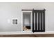 Charming playroom nook featuring a sliding barn door and window to let the imagination soar at 45 Iris Dr, Youngsville, NC 27596