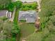 Aerial view displaying the beautiful layout of the home, the brick patio, and the surrounding nature at 4830 North Hills, Raleigh, NC 27612