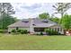 Expansive backyard featuring lush landscaping, screened-in porch, and well-maintained lawn at 4830 North Hills, Raleigh, NC 27612