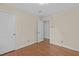 Cozy bedroom with hardwood floors and a view into the next room at 4830 North Hills, Raleigh, NC 27612