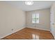 Well-lit bedroom featuring hardwood floors and a window providing natural light at 4830 North Hills, Raleigh, NC 27612