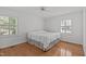 Bright bedroom with hardwood floors, two windows, and a ceiling fan at 4830 North Hills, Raleigh, NC 27612