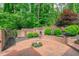 Charming brick courtyard with a classic design, decorative landscaping, and a peaceful atmosphere at 4830 North Hills, Raleigh, NC 27612