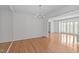 Bright dining room with hardwood floors, a chandelier, and an open floor plan that flows into the living area at 4830 North Hills, Raleigh, NC 27612