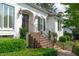 Close-up of the front entrance with brick steps, iron railing, and elegant sconces at 4830 North Hills, Raleigh, NC 27612