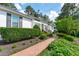 Charming white brick home with manicured landscaping and a brick walkway leading to the entrance at 4830 North Hills, Raleigh, NC 27612