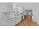 Spacious kitchen with white cabinets, granite countertops, stainless steel appliances, and a farmhouse sink at 4830 North Hills, Raleigh, NC 27612