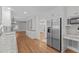 Open-concept kitchen with stainless steel appliances, granite countertops, and hardwood floors at 4830 North Hills, Raleigh, NC 27612
