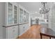 Gourmet kitchen with stainless steel appliances, granite countertops, and custom cabinetry with glass displays at 4830 North Hills, Raleigh, NC 27612
