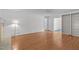 Bright living room with hardwood floors, a brick fireplace, and built-in shelves for ample storage at 4830 North Hills, Raleigh, NC 27612