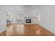 Spacious living room features a brick fireplace, hardwood floors, a ceiling fan, and patio access at 4830 North Hills, Raleigh, NC 27612