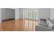 Open-concept living room with hardwood flooring offering plenty of natural light and access to other rooms at 4830 North Hills, Raleigh, NC 27612