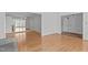 Well-lit living room featuring hardwood floors, large mirrors, and access to other rooms at 4830 North Hills, Raleigh, NC 27612