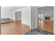 Spacious living room with hardwood floors, flowing seamlessly into adjacent rooms and a fireplace at 4830 North Hills, Raleigh, NC 27612