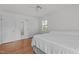Bedroom featuring hardwood floors and an open bathroom with a shower at 4830 North Hills, Raleigh, NC 27612