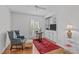 Home office featuring hardwood floors, built-in shelving, and a comfortable chair at 4830 North Hills, Raleigh, NC 27612