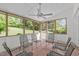Charming sunroom with brick floors, multiple windows, and a ceiling fan at 4830 North Hills, Raleigh, NC 27612