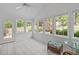 Relaxing sunroom with bright windows and a ceiling fan at 4830 North Hills, Raleigh, NC 27612