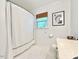 Bright bathroom featuring a shower with a white curtain, a window, and tile flooring at 5021 Lansdowne Dr, Durham, NC 27712