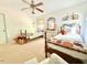 Charming bedroom featuring twin beds with decorative pillows, natural light, and carpeted floors at 5021 Lansdowne Dr, Durham, NC 27712