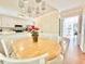 Cozy dining area features a light wood table, white chairs and a view into the kitchen at 5021 Lansdowne Dr, Durham, NC 27712