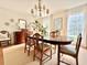 Elegant dining room with wood table, decorative lighting, and large window letting in natural light at 5021 Lansdowne Dr, Durham, NC 27712