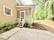 Exterior view of a house featuring a screened-in porch with stairs leading to the backyard at 5021 Lansdowne Dr, Durham, NC 27712