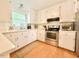 Kitchen with white cabinets, stainless steel appliances and a window for natural light at 5021 Lansdowne Dr, Durham, NC 27712