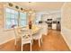 Bright kitchen with white cabinets, stainless steel appliances, and a sunny window overlooking the yard at 5021 Lansdowne Dr, Durham, NC 27712