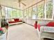 Inviting sunroom filled with natural light, cozy seating, and serene views of the outdoors at 5021 Lansdowne Dr, Durham, NC 27712