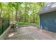 Relaxing back deck offers ample space with wooded backdrop and quaint seating area at 603 Gentry Ln, Hillsborough, NC 27278
