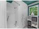 Bright bathroom features a shower and a shelving unit that offers great storage options at 603 Gentry Ln, Hillsborough, NC 27278