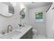 Elegant bathroom with dual sinks, marble countertops, subway tile backsplash, and modern gold fixtures at 603 Gentry Ln, Hillsborough, NC 27278