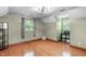 Spacious bedroom with wood floors, two windows, ceiling fan, and decorative moulding at 603 Gentry Ln, Hillsborough, NC 27278