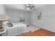 Cozy bedroom with hardwood floors, soft rug, and a comfortable bed bathed in natural light from the window at 603 Gentry Ln, Hillsborough, NC 27278