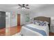 Inviting bedroom featuring hardwood floors, plush rug, and a comfortable bed with elegant bedding and natural light at 603 Gentry Ln, Hillsborough, NC 27278