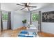 Bedroom features hardwood flooring, a modern ceiling fan, and natural light at 603 Gentry Ln, Hillsborough, NC 27278