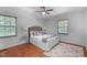 Serene bedroom with hardwood floors, natural light, and a comfortable bed with stylish bedding at 603 Gentry Ln, Hillsborough, NC 27278