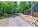 This home's long driveway is accompanied by a storage shed and wooded scenery at 603 Gentry Ln, Hillsborough, NC 27278