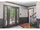 Inviting entryway features stylish door with glass, hardwood floors, and stairway at 603 Gentry Ln, Hillsborough, NC 27278