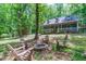 Relax by the fire pit surrounded by Adirondack chairs in the wooded backyard at 603 Gentry Ln, Hillsborough, NC 27278