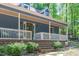 This cozy front porch features ample seating and decorative features for a welcoming entrance at 603 Gentry Ln, Hillsborough, NC 27278