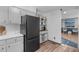 Bright kitchen with stainless appliances, light gray cabinets, modern fixtures, and durable modern flooring at 603 Gentry Ln, Hillsborough, NC 27278