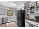 Bright kitchen with stainless appliances, light gray cabinets, wood accents, and durable modern flooring at 603 Gentry Ln, Hillsborough, NC 27278