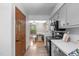 Bright kitchen with stainless appliances, light gray cabinets, and durable modern flooring overlooking the dining area at 603 Gentry Ln, Hillsborough, NC 27278