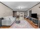 Bright living room with hardwood floors, gray trim, modern lighting, and comfortable seating near a brick fireplace at 603 Gentry Ln, Hillsborough, NC 27278