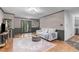 Bright living room with hardwood floors, modern lighting, and neutral decor with easy access to stairs at 603 Gentry Ln, Hillsborough, NC 27278