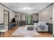 Bright living room with hardwood floors, modern lighting, and neutral decor with easy access to entryway at 603 Gentry Ln, Hillsborough, NC 27278
